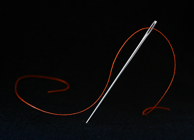 a needle pulling thread
