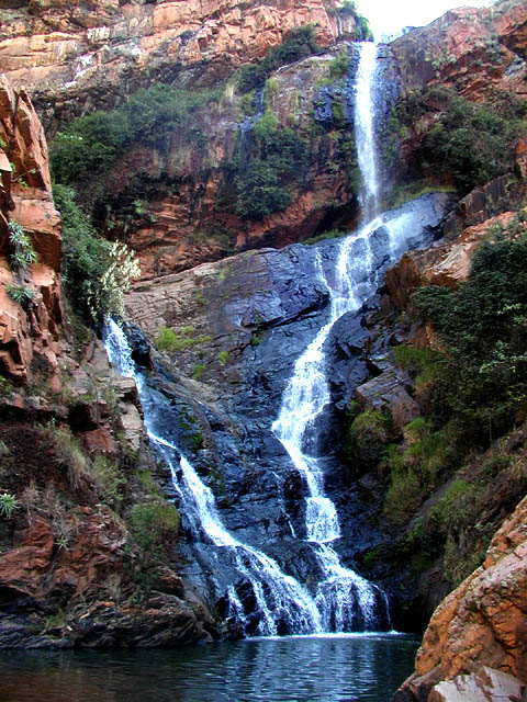 red cliff and waterfall