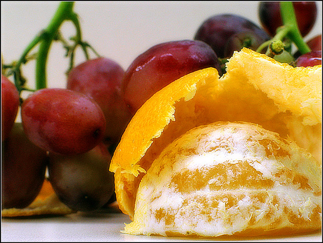 half tangerine with grapes