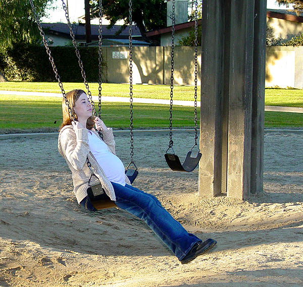 Lonely Pregnant Woman on Swing