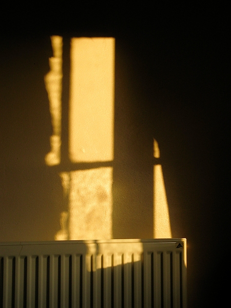 A wall, a radiator, and light.