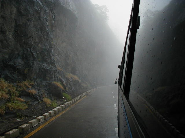 Black bus zooming in the White Fog