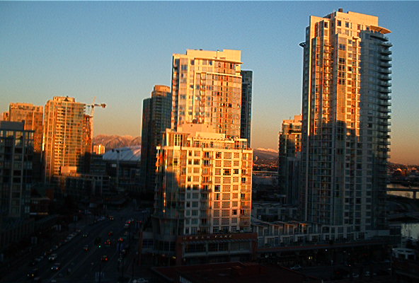 skyscrapers painted orange by the evening sun