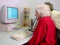 Elderly folk have computer lessons.