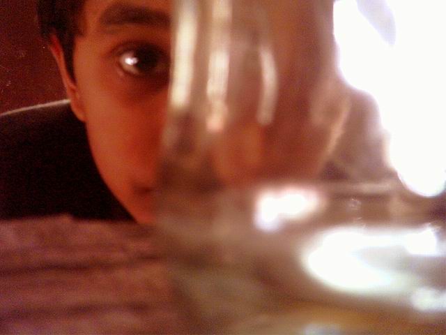 a boy wathing somthing from the glass