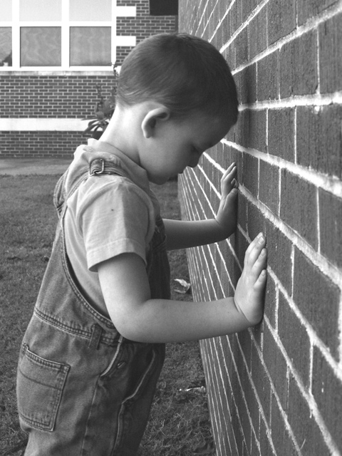 Holding up the wall at recess.
