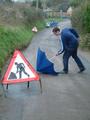 'Warning' Strange Man Having Trouble With Umbrella in Road Ahead