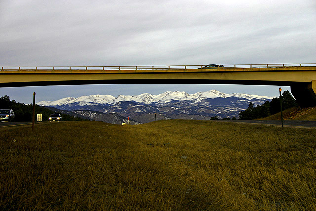 Bridge over I-70, framing the Rockies.