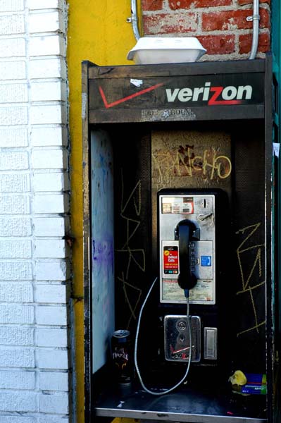 In these days when everyone has their own cell phone...this payphone is used for trash