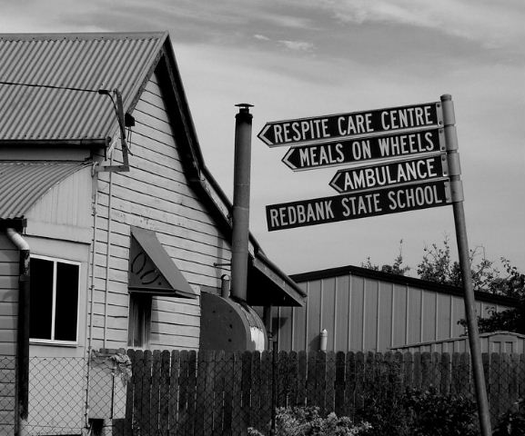 Leaning sign post.