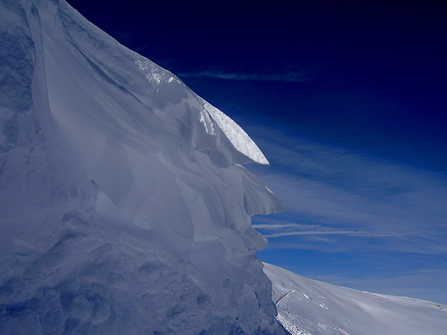 Wind carved snow  and blue sky at 13,000' elevation.