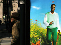 Man at Bus Stop with Advertisement