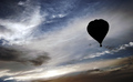 Black Balloon in Stormy Skies