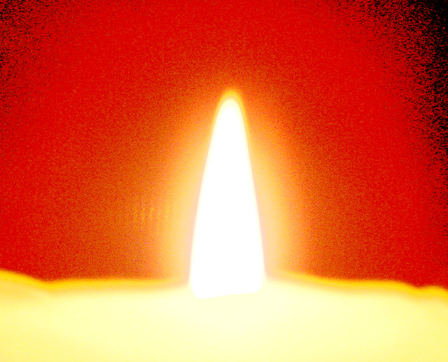 Candle Glowing on Red