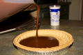 Pouring a chocolate tart