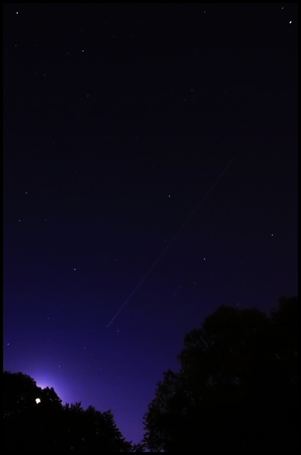 Comet Streaks the Purple Sky