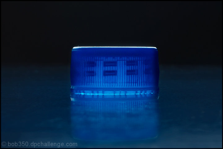 Bottle cap on dusty desk