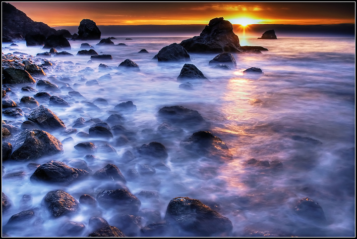 Sunset fantasia of a rocky beach