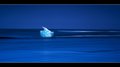 Iceberg Melting on a Smooth Wave  