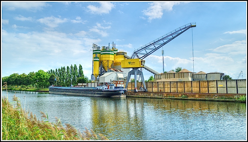 Barge unloading sand at a concrete and cement plant