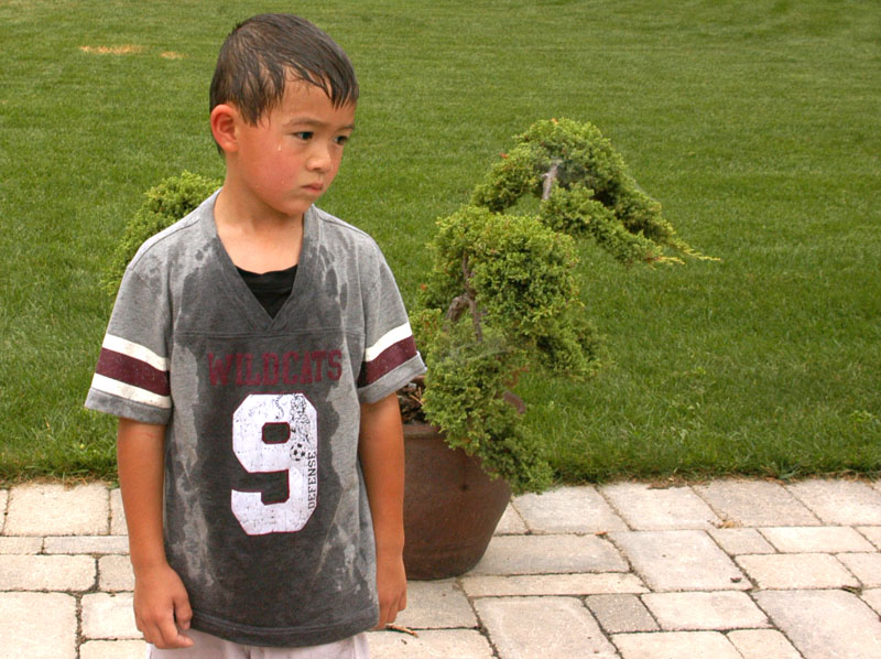 Young boy with Serious Look Observing Another Child Having a Fit