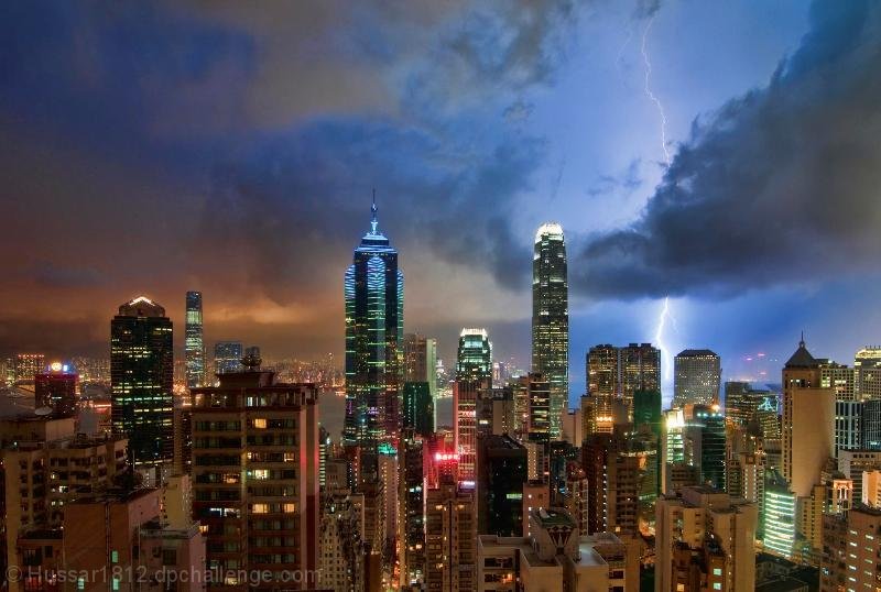 Charged Skyscape over Glowing Cityscape
