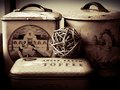 3 ole tins and a wooden ball