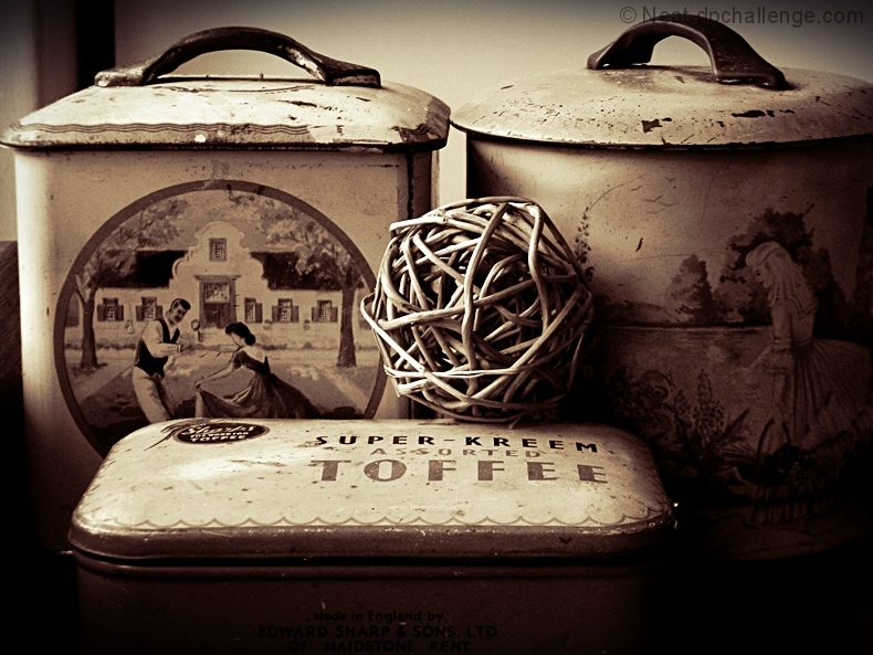 3 ole tins and a wooden ball