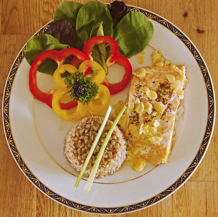 Baked salmon with garlic/almond butter, whole barley and vegetables.