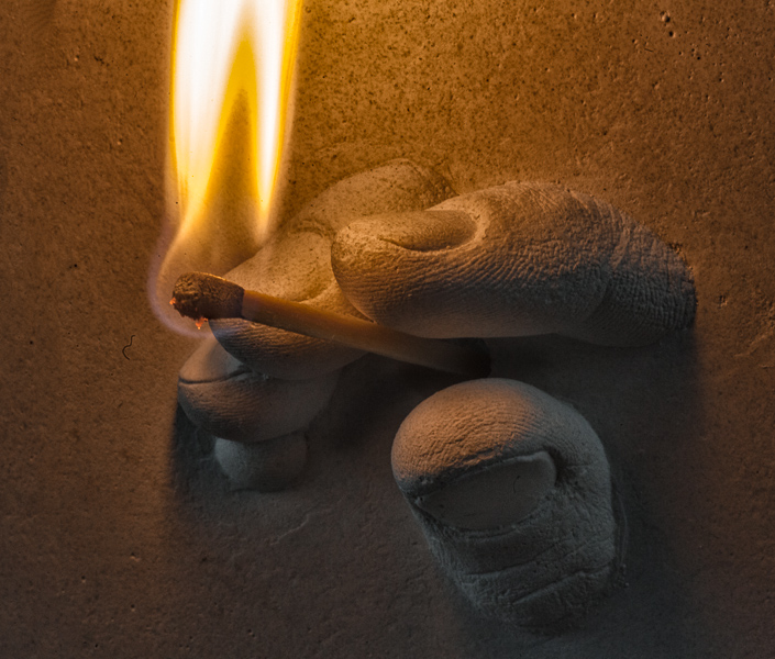 Finger tips with burning match