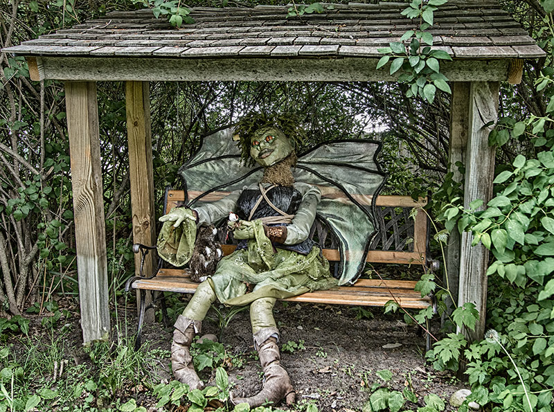 And the Fairy sat upon the garden bench, feeding the rabbit and birds.