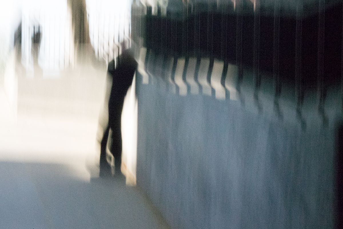 man leaning on wall
