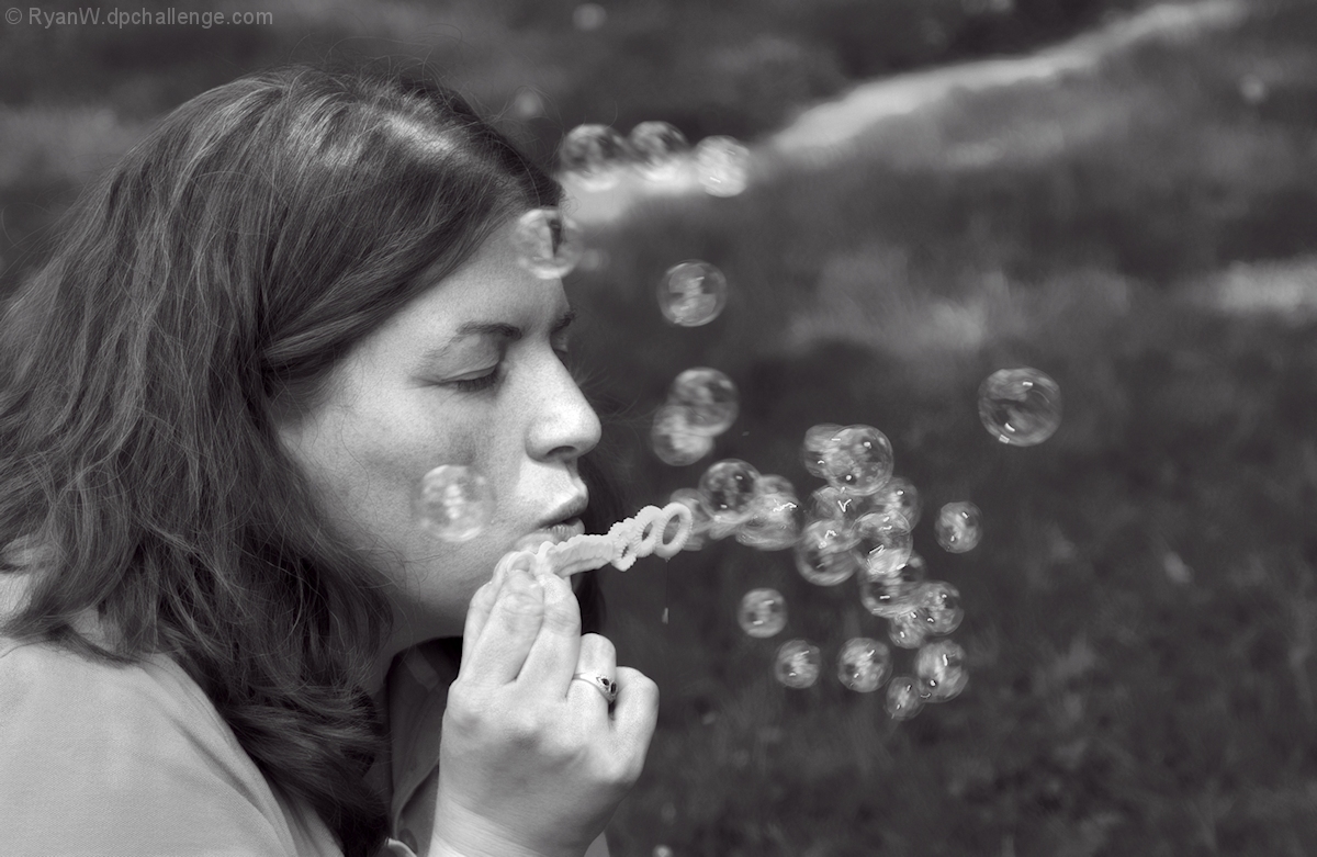 Blowing bubbles for her boy