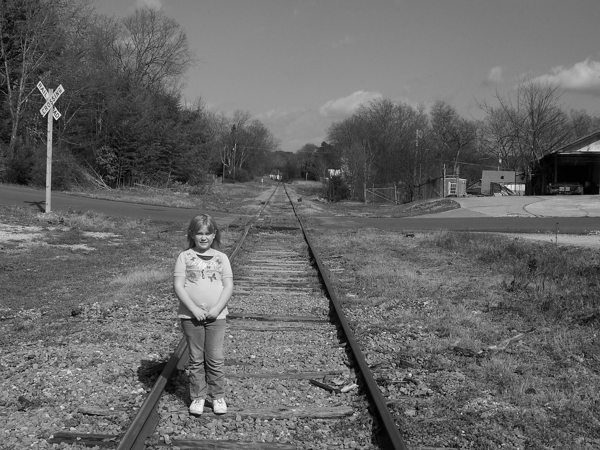 Kylei on train tracks.