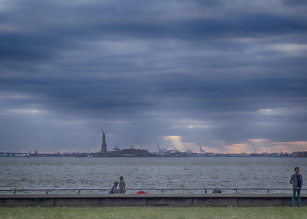 city shoreline on the brink of a passing storm