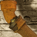 old rust encrusted (but still servicable) drain pipe in the basement