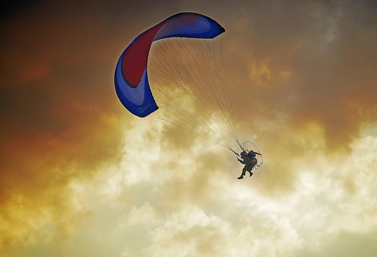 motor paraglider at sunset 