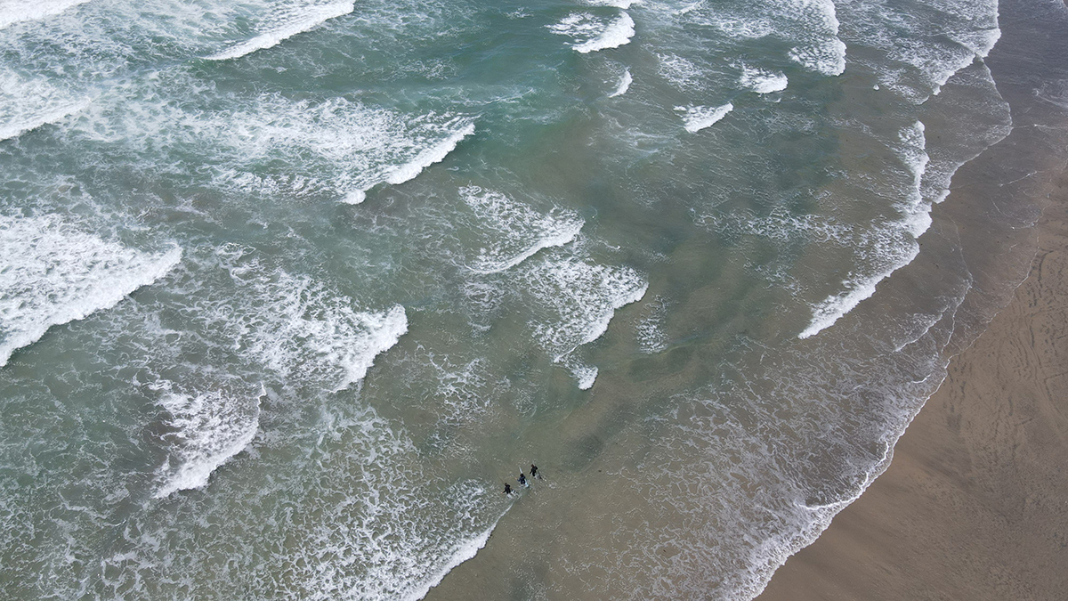 Three men in a sea