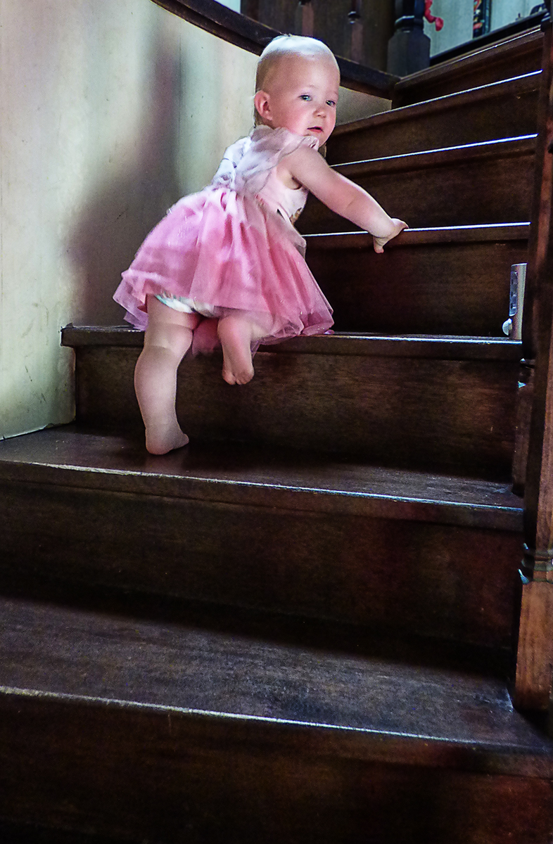 To a very LITTLE girl a stair case is very BIG.