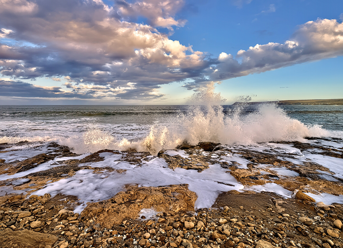 A Crashing Wave Reaches Up To Kiss the Clouds