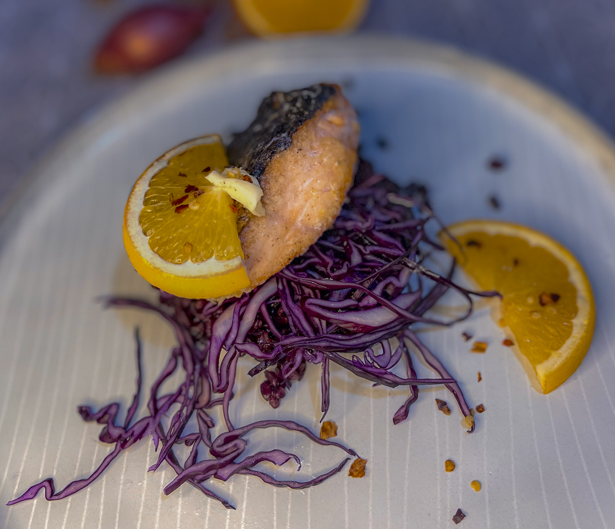 salmon on black rice and red cabbage with orange-chili butter