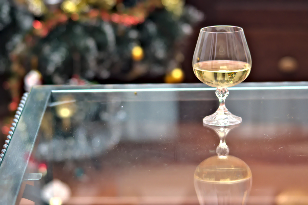A glass goblet with white wine