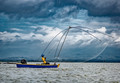 Blue Skiff, Yellow Shirt, Midday Fishing