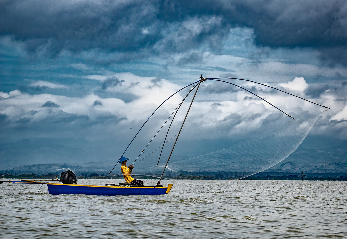 Blue Skiff, Yellow Shirt, Midday Fishing