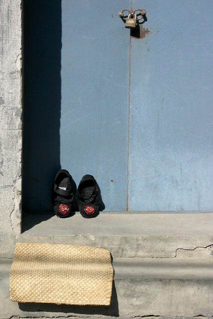 Blue Door, Black Shoes, Yellow Mat