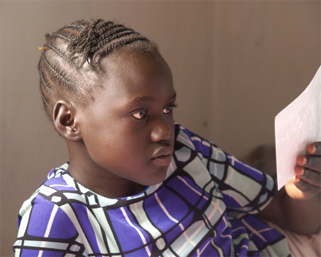 Nyangok looks at a photo of her father