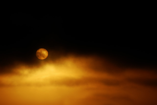sun behind clouds