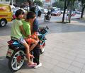 Three Kids On Motorcycle Taxi