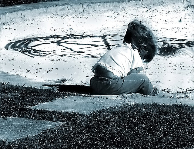 Little girl playing with sand