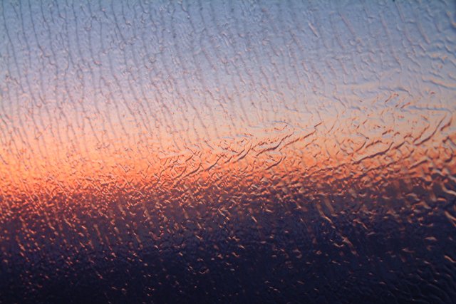 Rain-streaked Window at Sunrise